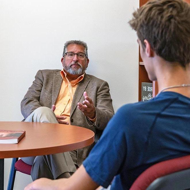 Karel Sovak mentoring a young college student.